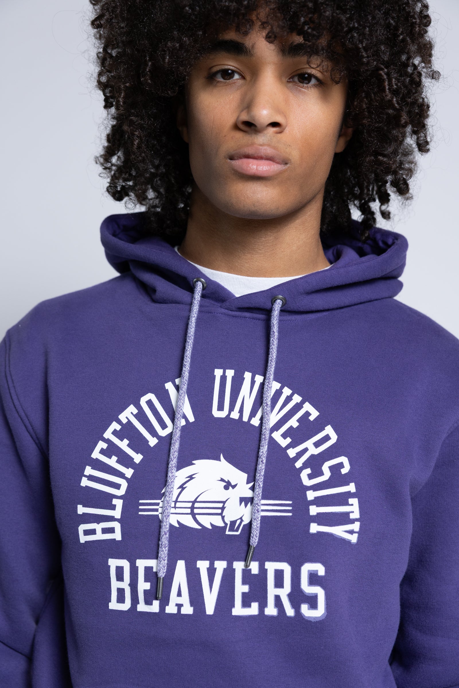 Person wearing a purple hoodie with 'Bluffton University Beavers' text and logo.